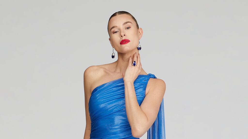 Blue Halston gown and Martin Katz tanzanite earrings and ring